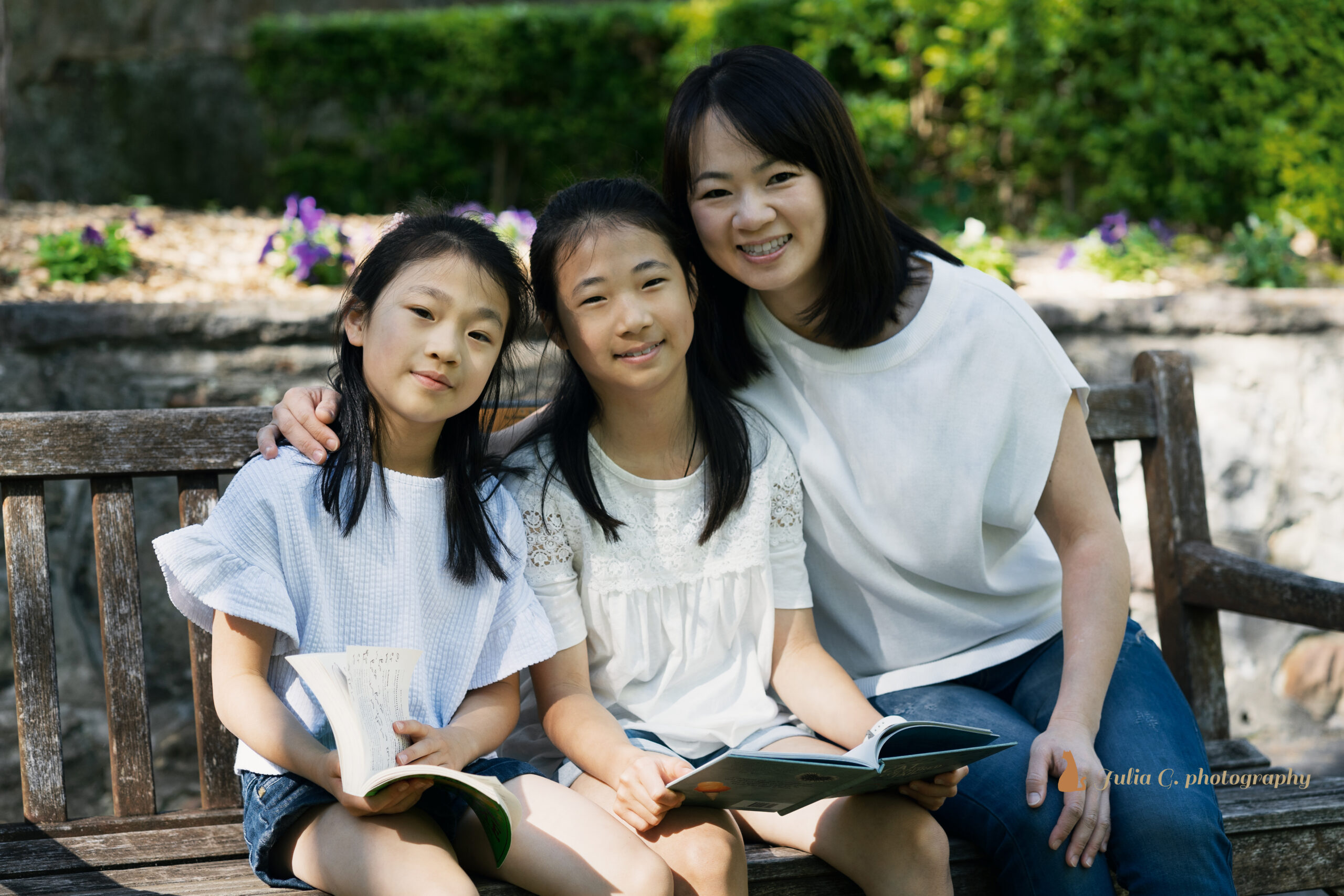 Asian mother and two daughters sitting in the park